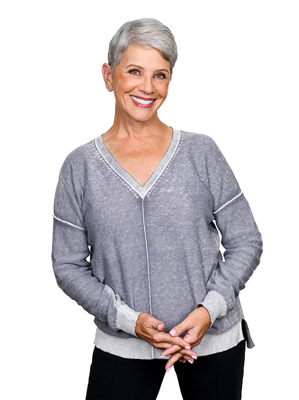 A mature woman smiling with her dental crowns